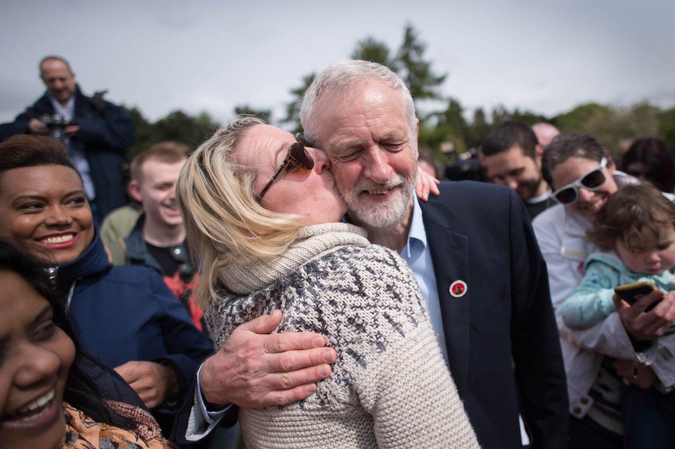 Labour leader Jeremy Corbyn is kissed by a supporter at a rally in Harlow, Essex.