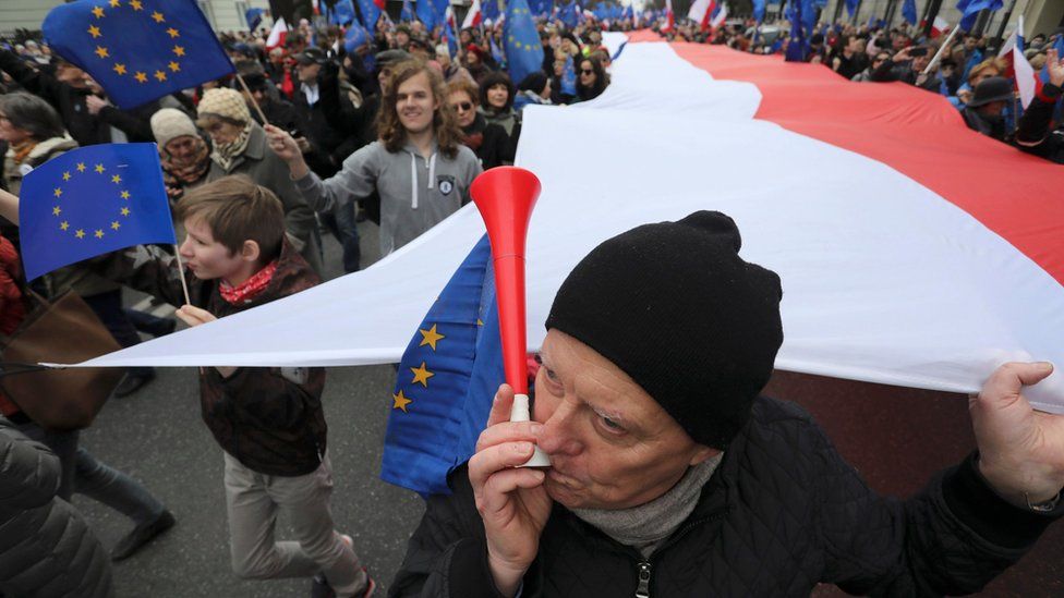 A man blows a horn during a march called "I love Europe" to celebrate the 60th anniversary of the Treaty of Rome in Warsaw, Poland March 25, 2017