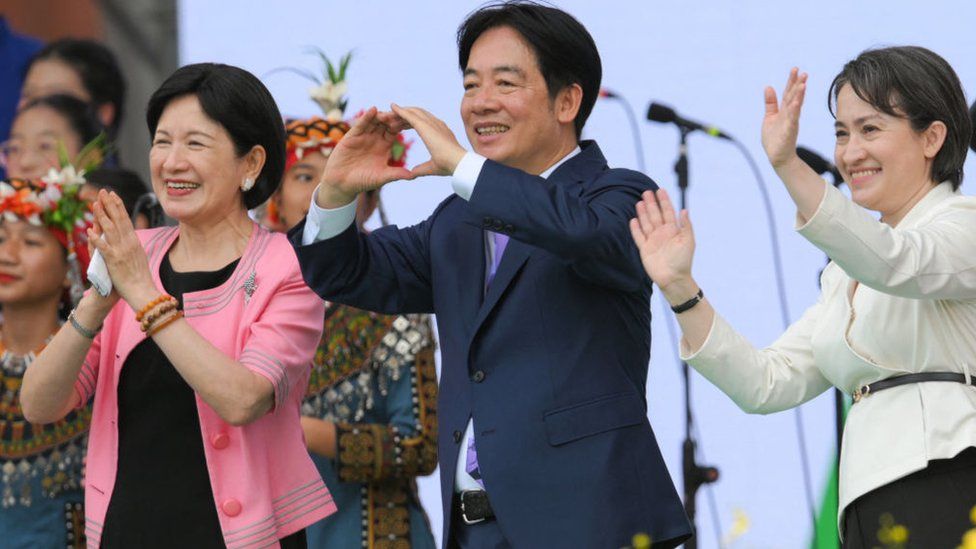 Taiwan's President Lai Ching-te (C), incoming First Lady Wu Mei-ju (L) and Vice President Hsiao Bi-khim (R) react after his inaugural speech after being sworn into office during the inauguration ceremony at the Presidential Office Building in Taipei on May 20, 2024.