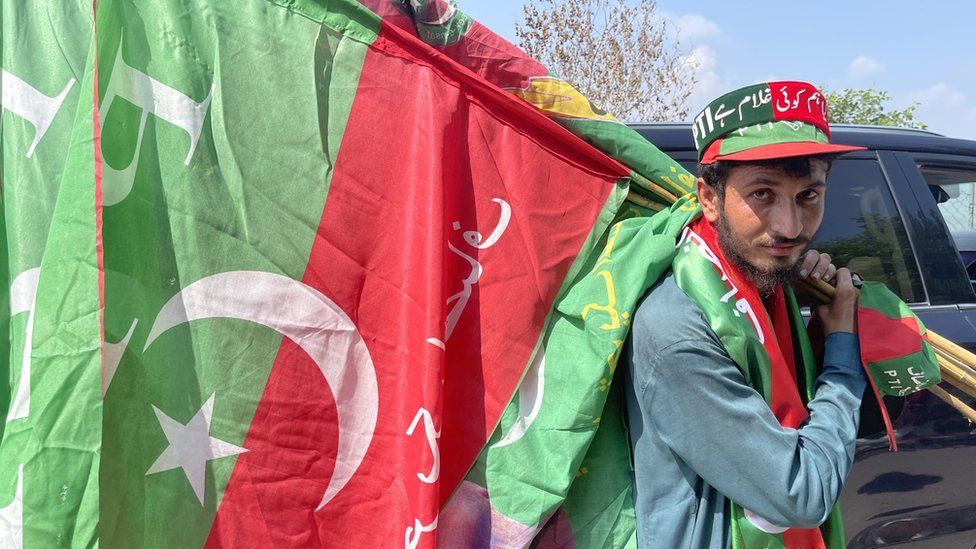 Mohammed Khaliq holding a PTI flag