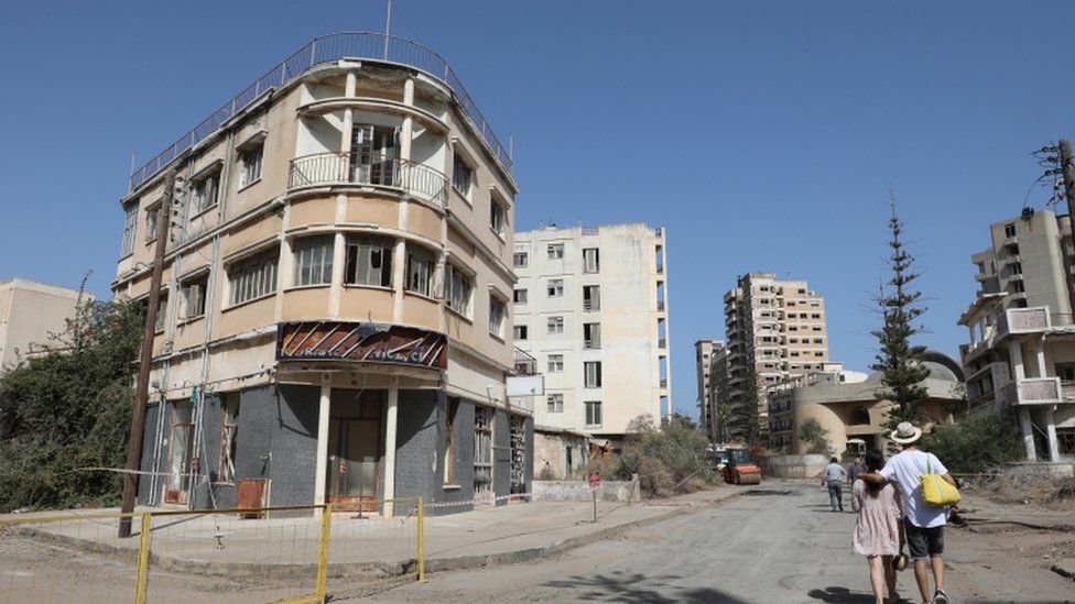 People walk through a newly-opened street of abandoned quarter of Varosha in Famagusta, Cyprus, 08 October 2020