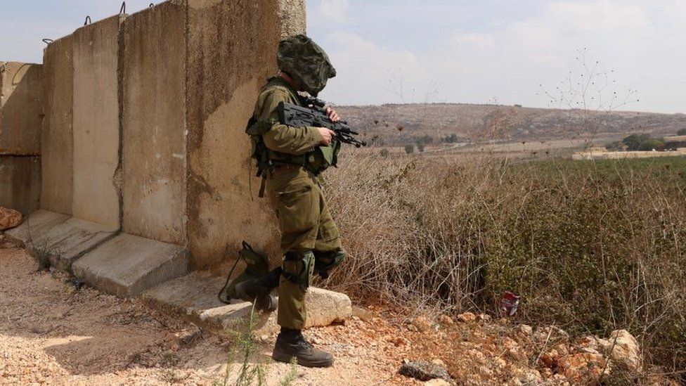 Israeli soldier stands in position in northern town of Metula on 8 October 2023