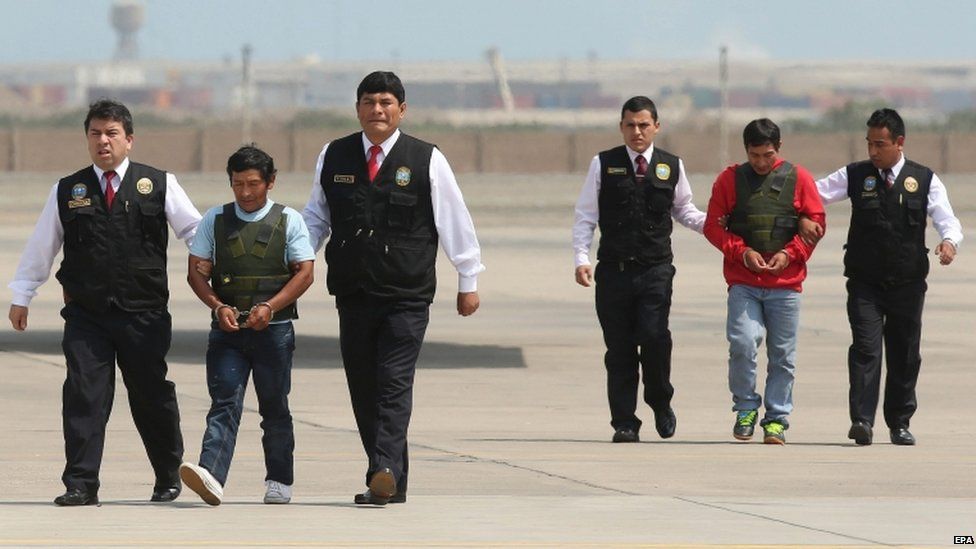 Alexander Alarcon Soto, known as "Comrade Renan" (2-R), and Dionisio Ramos, known as "Comrade Yuri" (2-L), are presented to the media at the international airport in Lima, Peru, 10 August 2015