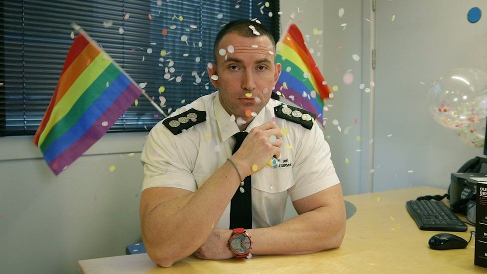 A still from the video showing a man surrounded by confetti