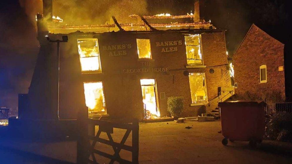 The Crooked House on fire