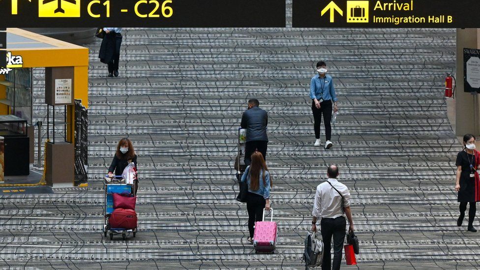 Travellers walk along the transit hall of Changi International Airport in Singapore in March 2022