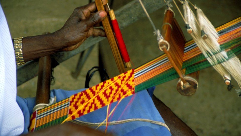Person weaving kente