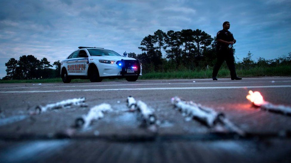 A sheriff's deputy in Harris County, Texas, responds to a fire at a chemical plant