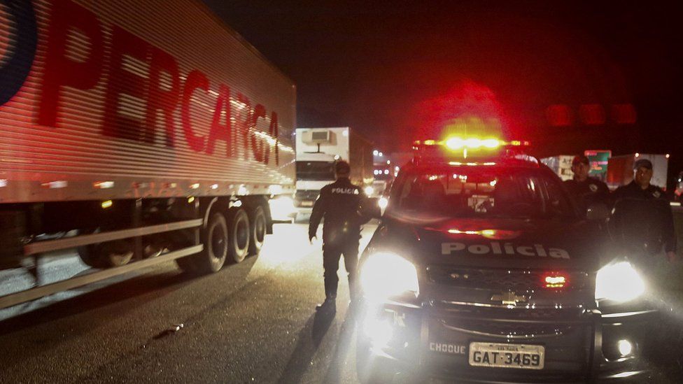 Police try to clear a blocked road in the city of Sao Bernardo do Campo during the sixth day of a truckers' strike on May, 26, 2018