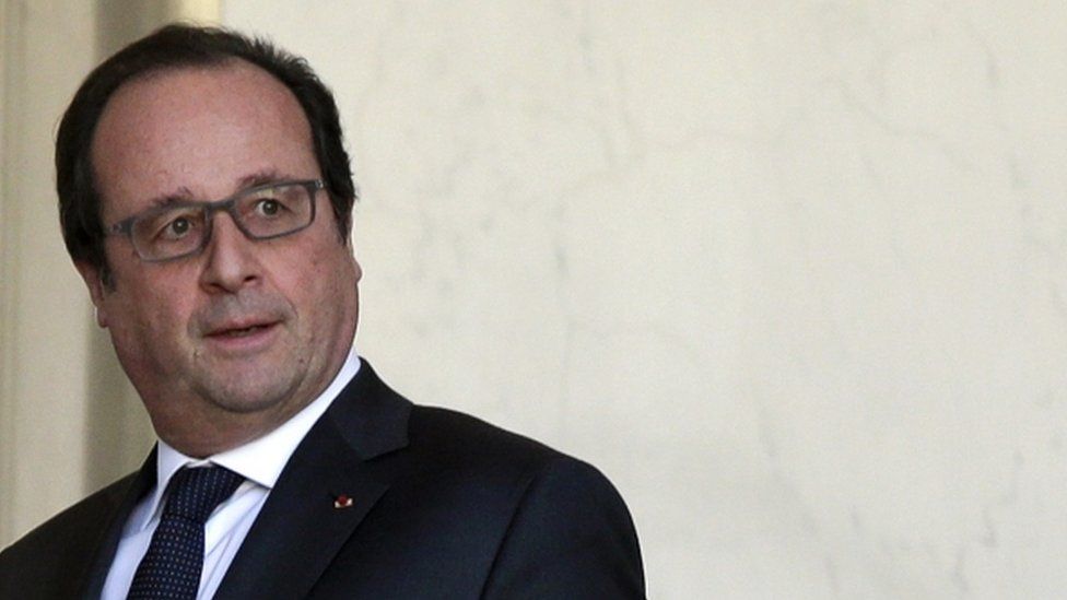 French President Francois Hollande walks to his office at the Elysee Palace in Paris