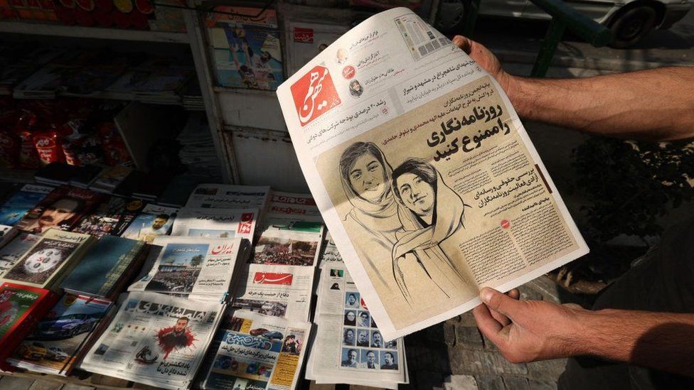A newspaper shows arrested Iranian journalists