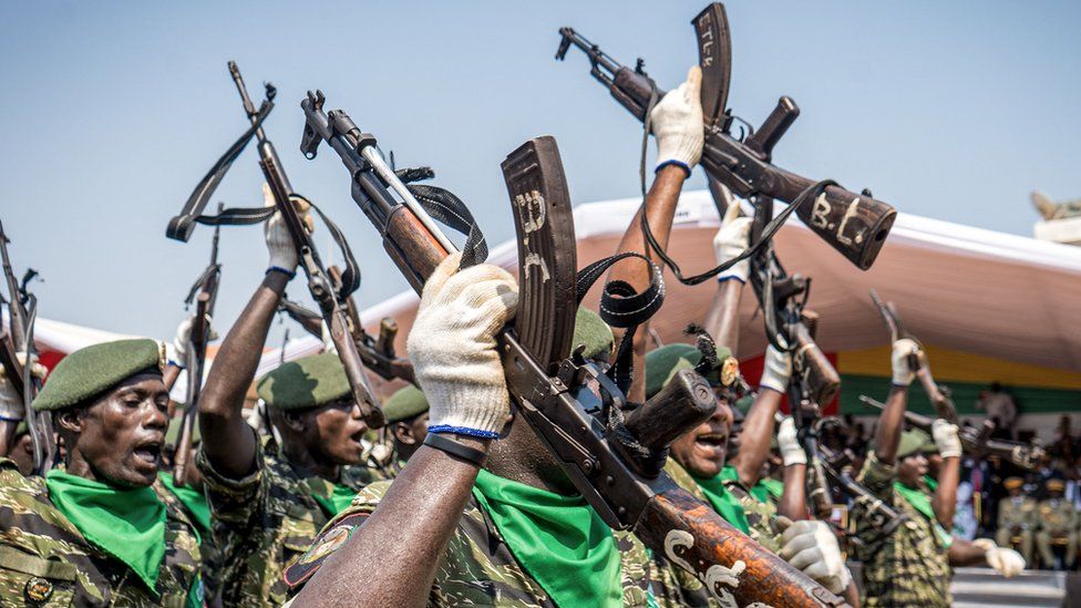 Soldiers with the People's Revolutionary Armed Forces (FARP) hold their guns in the air during Guinea-Bissau's 50th Independence Day celebrations in Bissau on November 16, 2023. (
