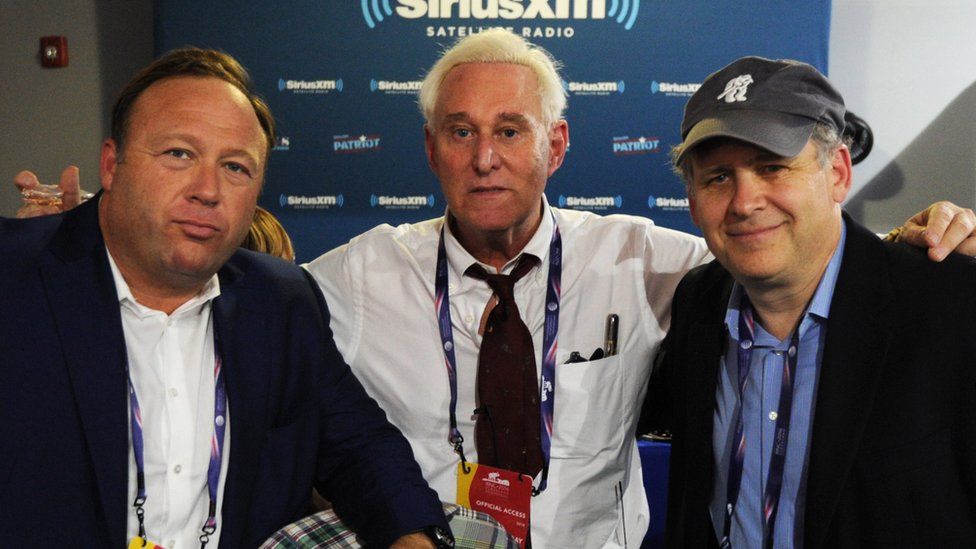 Jones along with former Trump campaign advisor Roger Stone and journalist Jonathan Alter at the 2016 Republican National Convention in Cleveland, Ohio