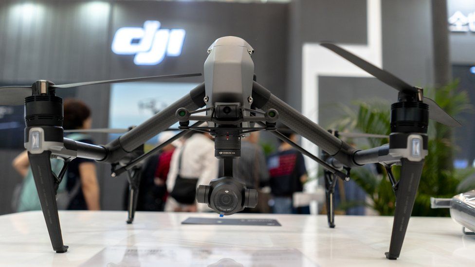 Drones made by a Chinese company, DJI, are shown on a table