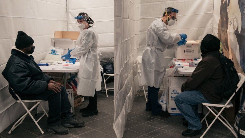 Medical workers prepare tests at a new testing site inside the Times Square subway station in New York City