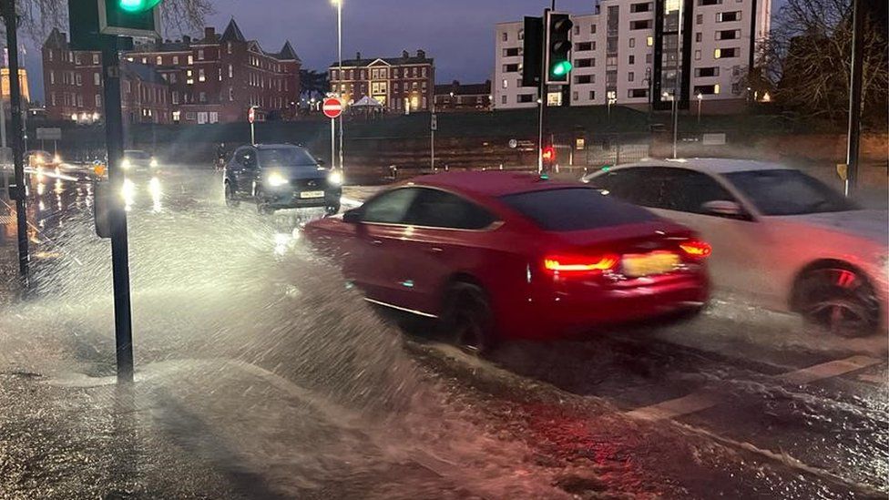 Cars driving through floodwater