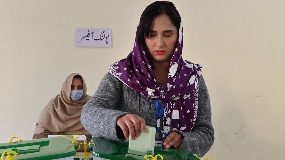 A woman casts her ballot at a polling station during Pakistan's national elections in Islamabad on February 8, 2024.
