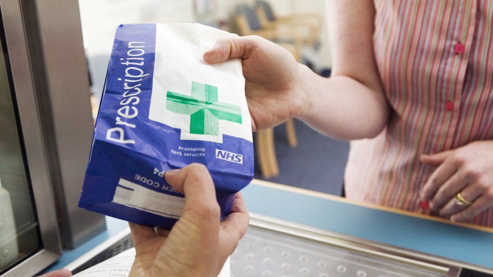 Prescription bag being handed to patient