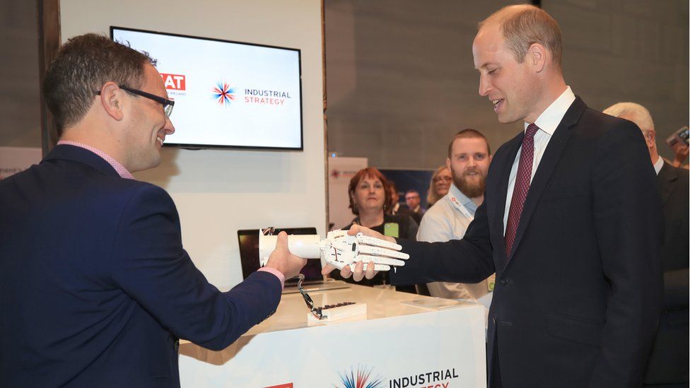 The Duke of Cambridge shakes hands with a robotic hand made by a 3D printer during a visit to the International Business Festival at the Exhibition Centre Liverpool