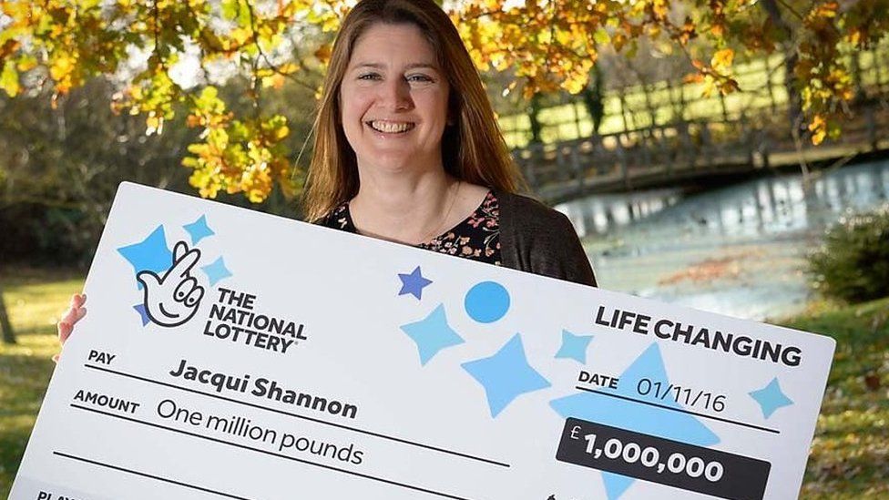 Lottery winner Jacqui Shannon holding £1 million cheque