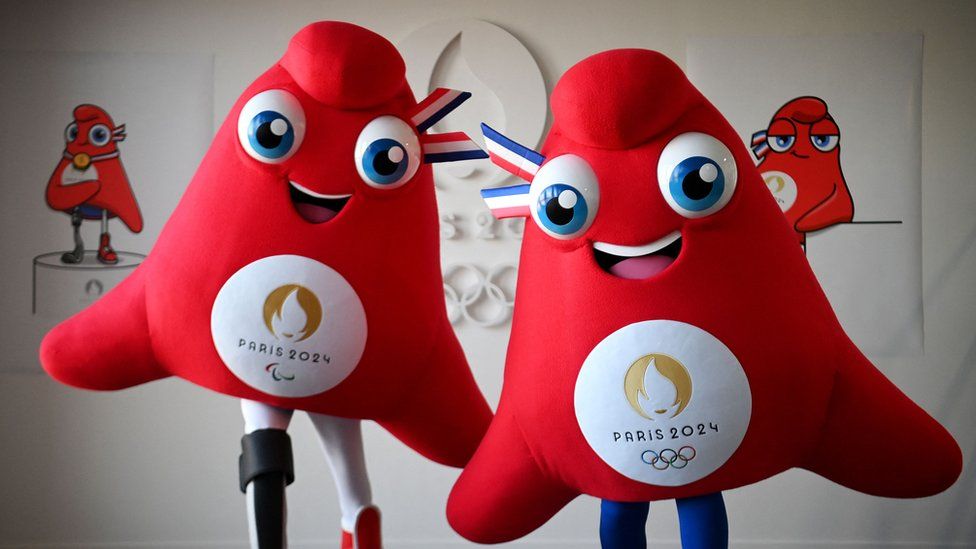 Actors model life-size versions of Les Phryges, the two mascots for the Olympic and Paralympic Games in Paris