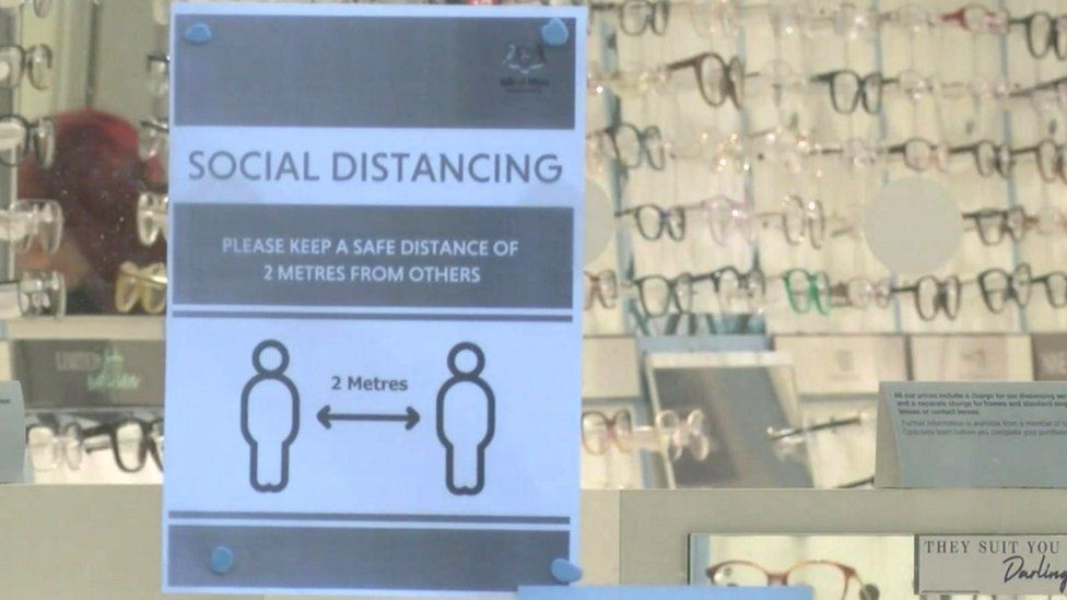 Social distancing sign in shop window