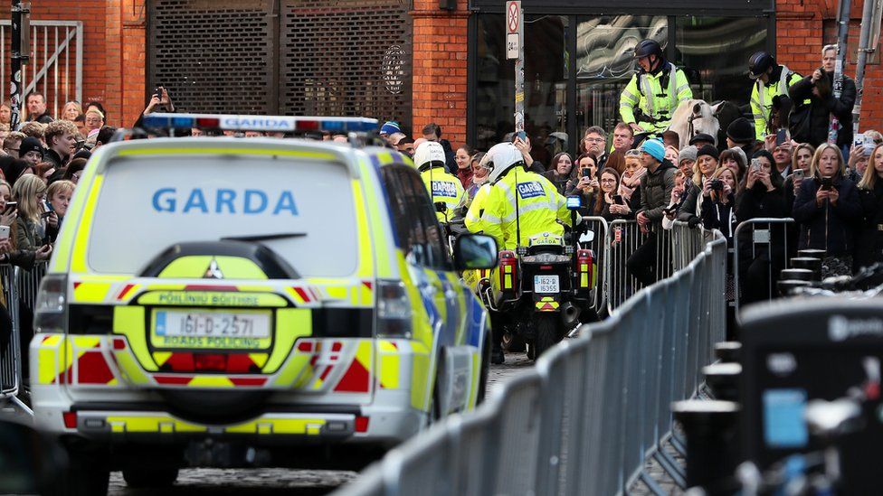 Gardai (Irish police) ushered the royal couple to and from the Jigsaw charity as crowds cheered