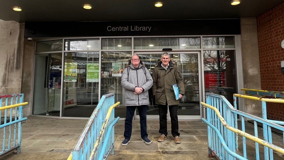 Graham and Geoff stood in front of Hull's Central Library