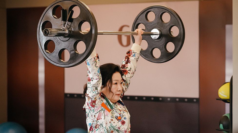 Super-strong grandmother Gil Joong-gan lifting huge dumbbells