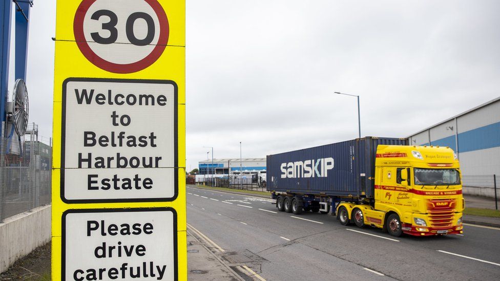 Haulage lorry drives passed a sign at Belfast Port welcoming travellers to the Harbour Estate