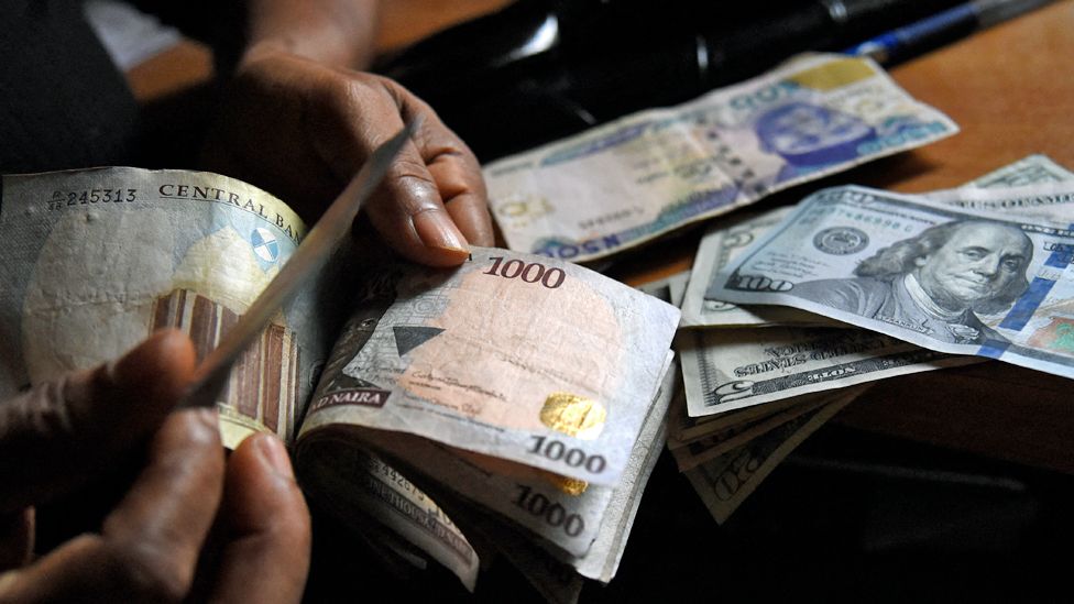 A man exchanges Nigeria's currency naira for US dollars in Lagos, Nigeria - April 2021