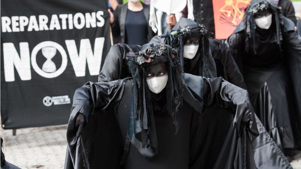 Extinction Rebellion's Black Brigade join a protest outside corporate offices of oil company Shell demanding an end to extraction of fossil fuels and reparations for the communities affected by environmental pollution caused by oil spills in the Niger Delta, on 08 September, 2020 in London, England.