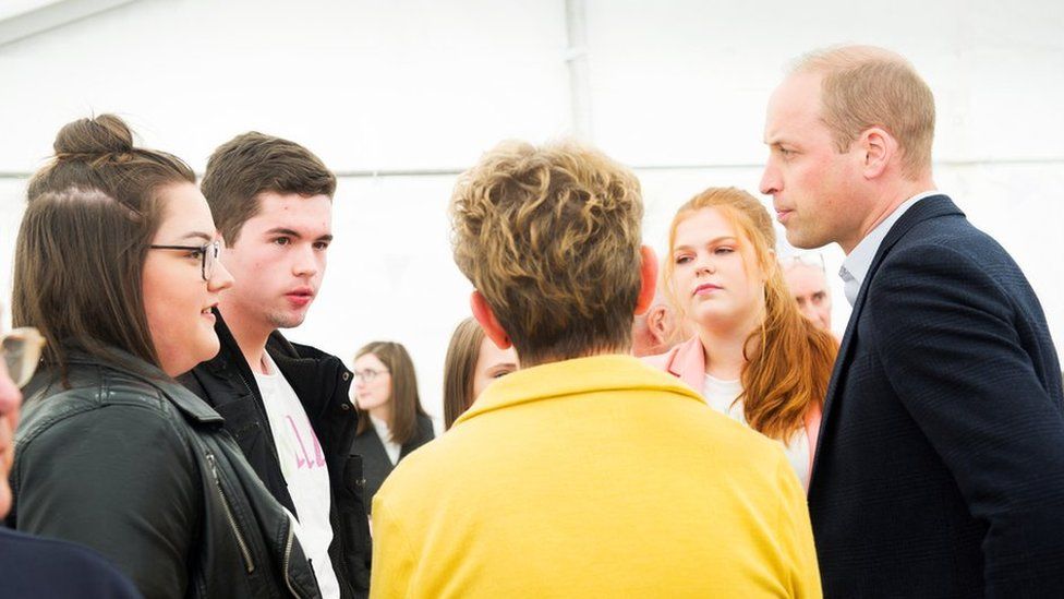 Prince William talking to group members