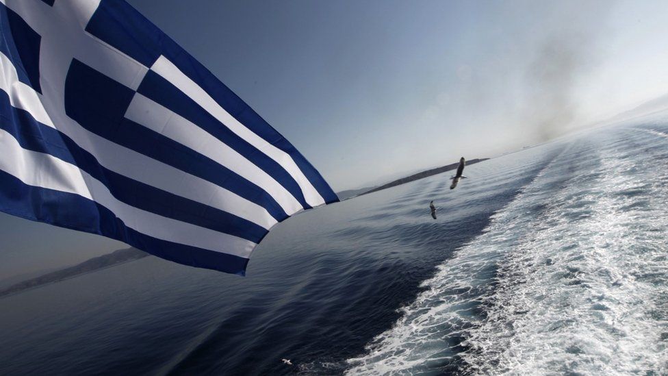 The Greek flag flying at the stern of a ship