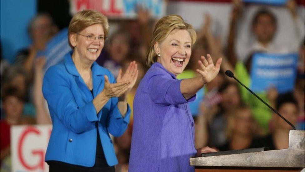 Presumptive Democratic presidential nominee Hillary Clinton (R) waves to the crowd with Senator Elizabeth Warren, D-Massachusetts, (L) during a campaign stop