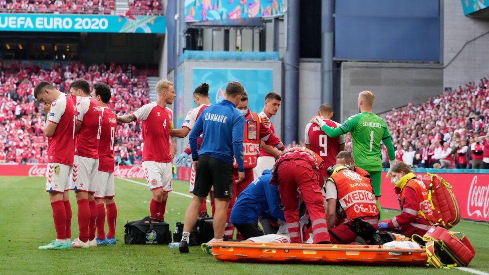 Christian Eriksen (Hidden) of Denmark receives medical treatment during the UEFA Euro 2020 Championship Group B match between Denmark and Finland on June 12, 2021 in Copenhagen, Denmark.