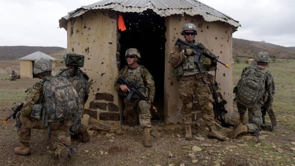 US troops take position near a hut during a combined training exercise with Senegalese troops
