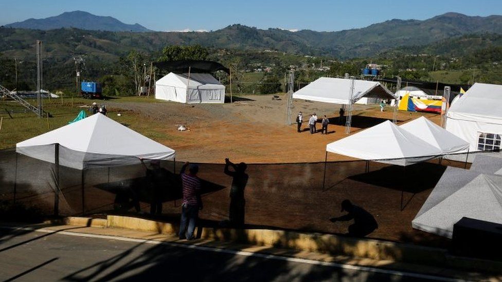 Men work to prepare a venue for an event attended by France"s President Francois Hollande and his Colombian counterpart Juan Manuel Santos in the FARC concentration zone of Caldono, Colombia, January 23, 2017.