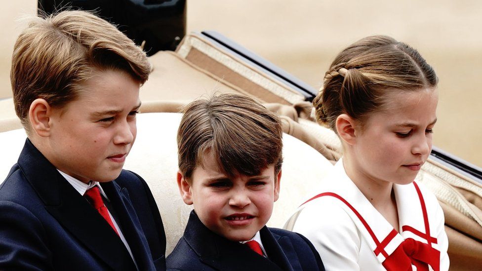 Prince George of Wales, Prince Louis of Wales and Princess Charlotte of Wales ride along in the carriage