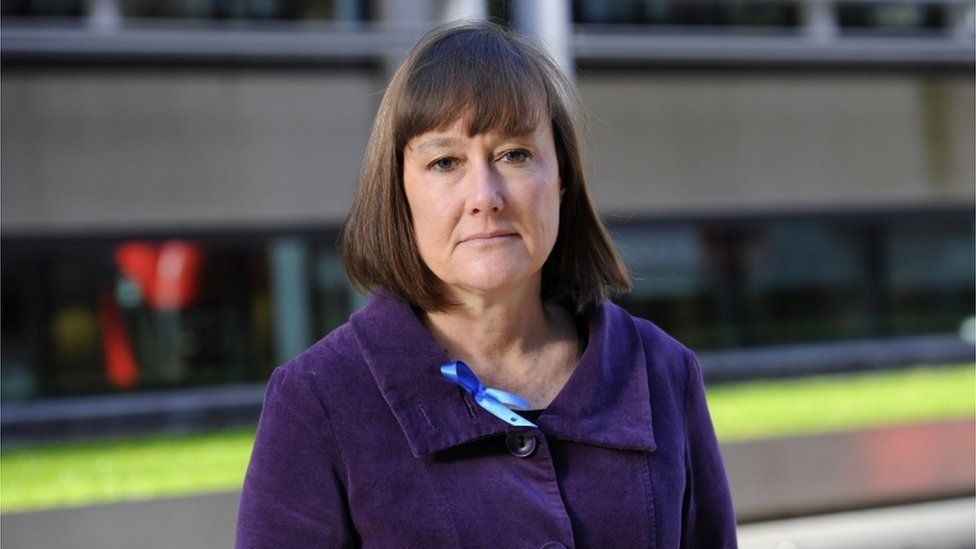 Jo Stevens in a purple coat looking at the camera