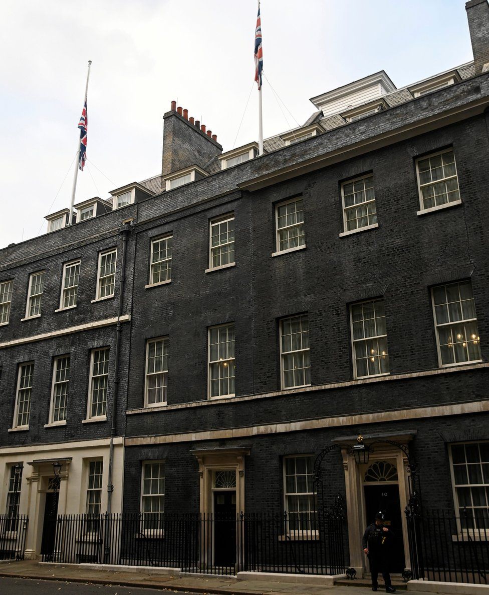 Flags are seen at half maston the roof of 10 Downing Street,