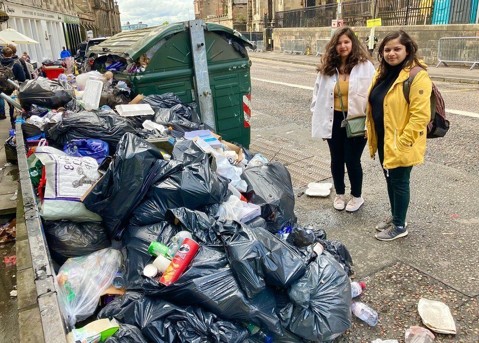Tourists beside a mountain of rubbish in Edinburgh