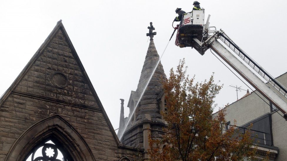 Firefighters pour water into Middle Collegiate Church from above