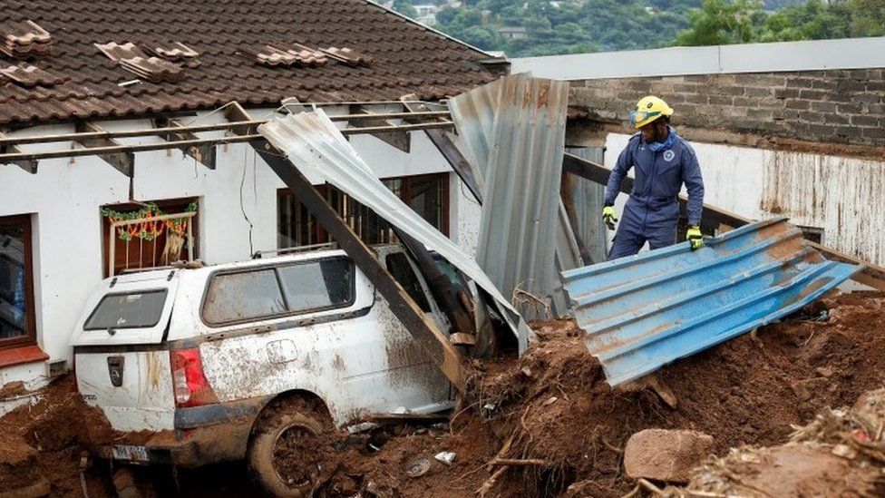 A member of the search and rescue team looks through debris in Dassenhoek near Durban, South Africa, April 17, 2022