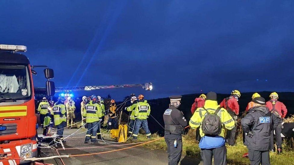 Emergency service personnel at the top of the cliff