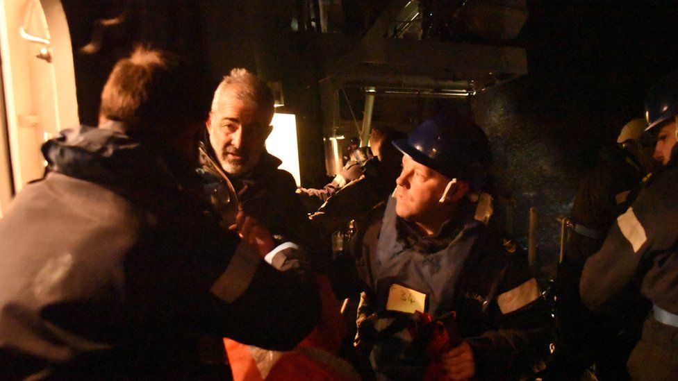 A Royal Navy picture handout of crew members being rescued