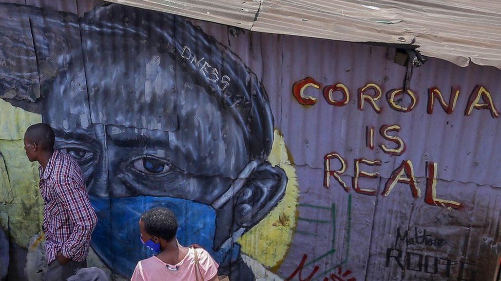 Artwork is seen on the wall of a house in Mathare slums with a man wearing a facemask and words saying coronavirus is real.