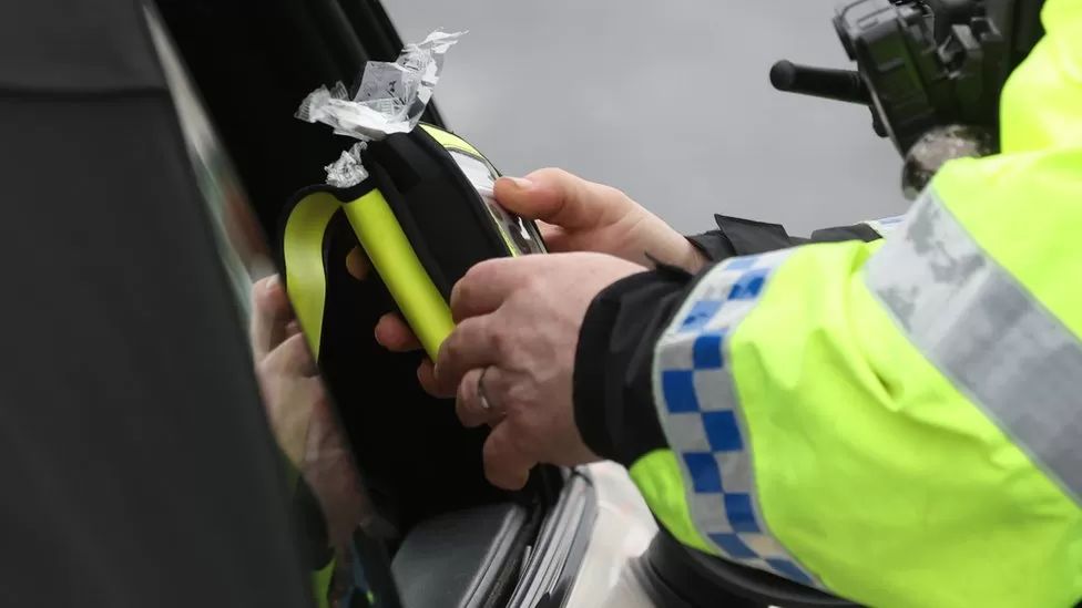 Police officer with drug-driving test kit