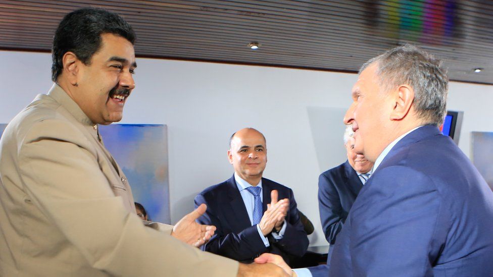 Venezuelan President Nicolas Maduro (L) greeting the head of the Russian state-owned oil giant Rosneft, Igor Sechin