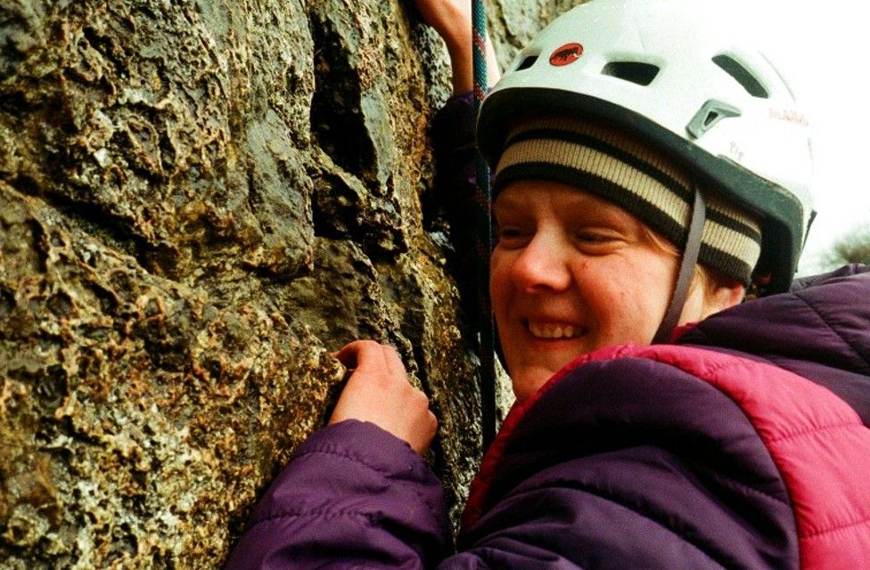 Pip Rowlands climbing rock
